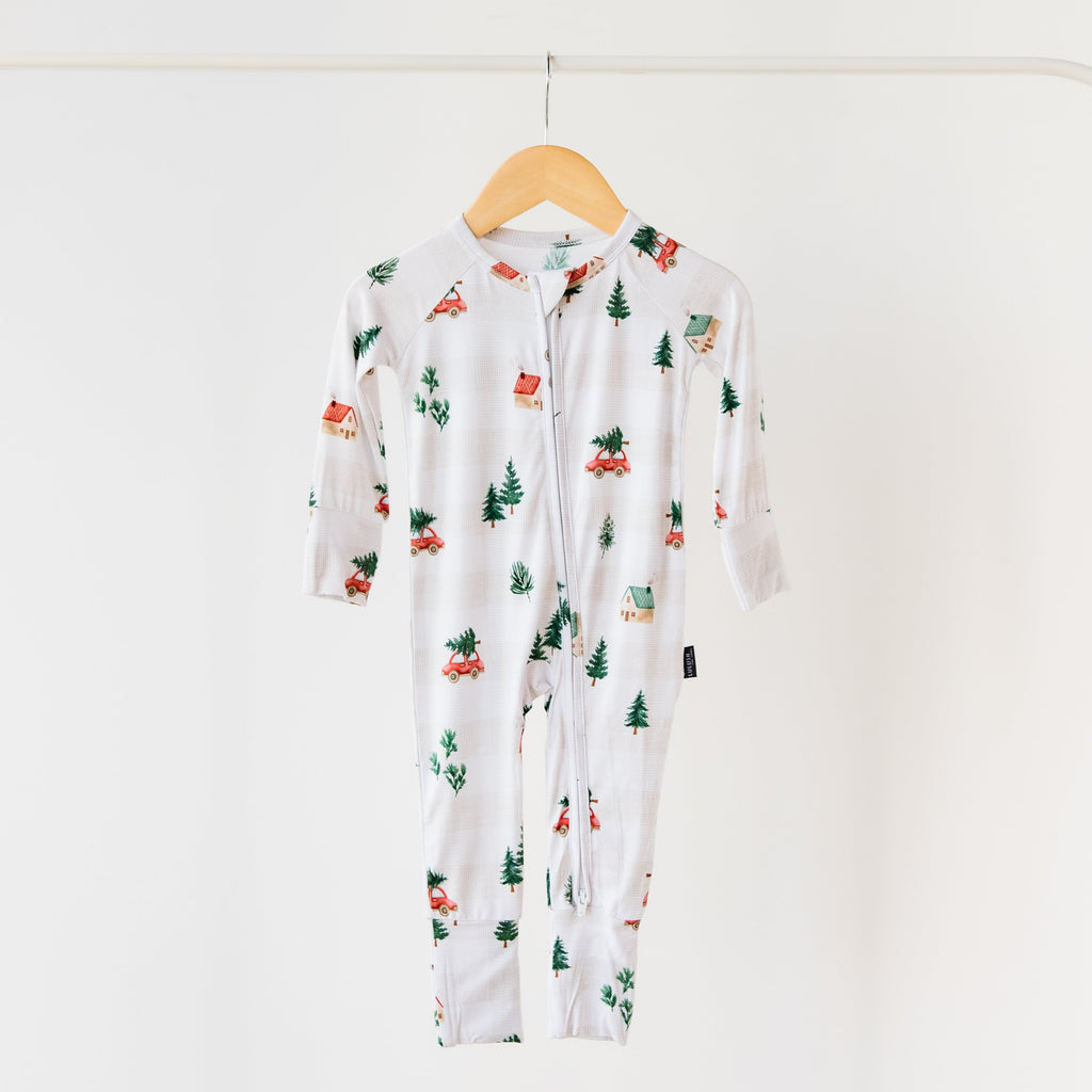 Floral-patterned baby onesie on a hanger against a white background